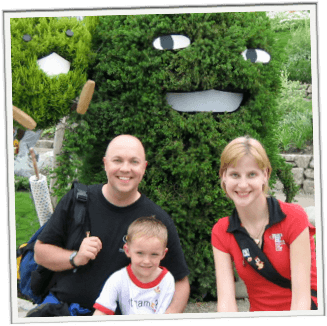 Jeffrey, Joshua and Mocha in front of a topiary face